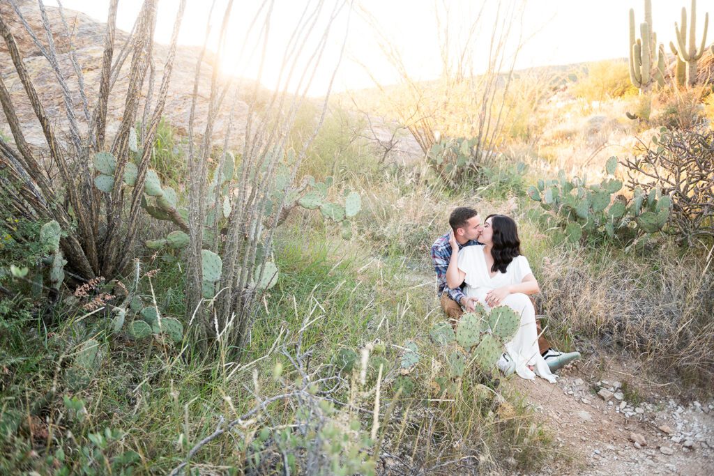 man and woman kissing in the desert